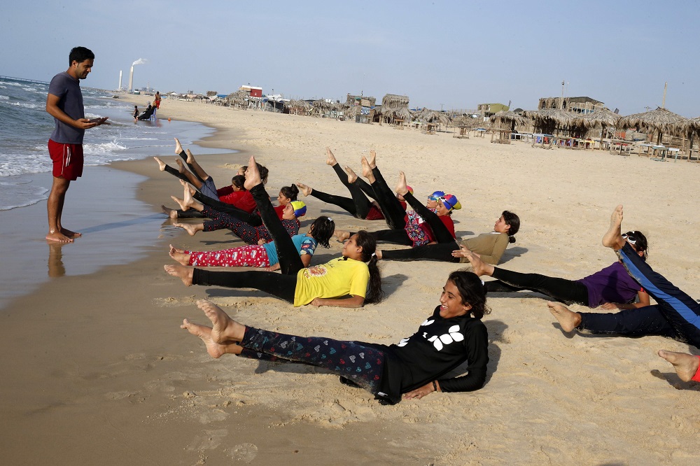 Young Palestinian members of a swimming club, participate in a group exercise on the beach during a training session in Beit Lahia in the northern Gaza Strip October 4, 2018. — AFP pic  