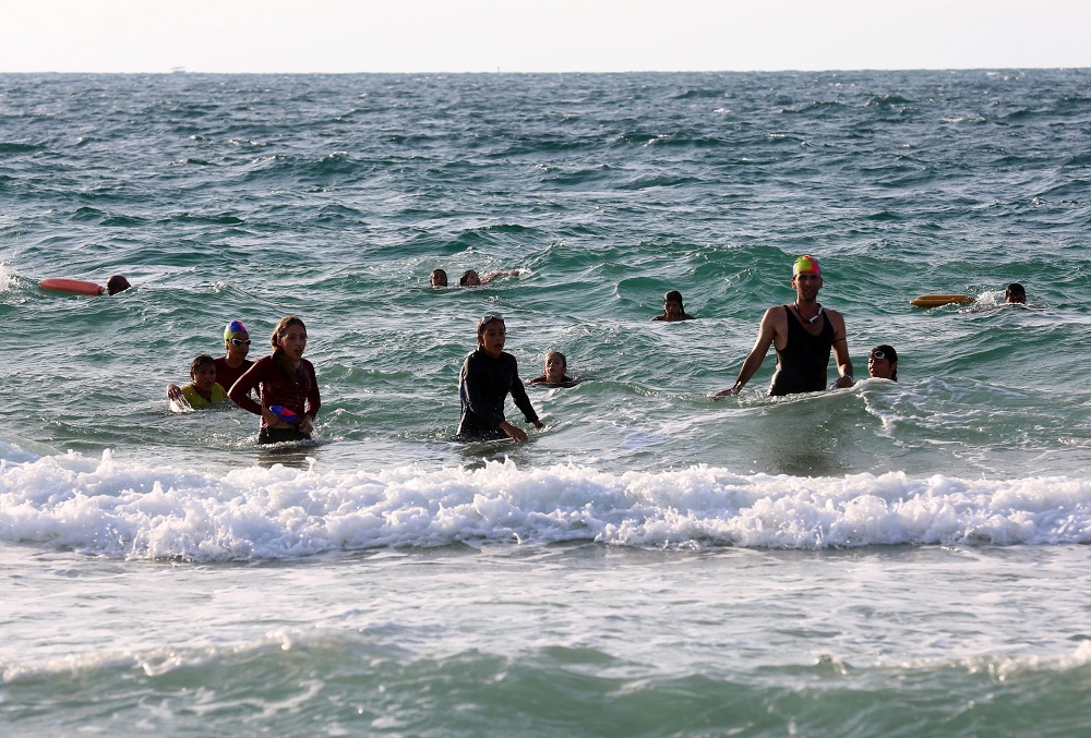 Young Palestinian members of a swimming club, swim in the sea during a training session in Beit Lahia in the northern Gaza Strip October 4, 2018. u00e2u20acu201d AFP pic  