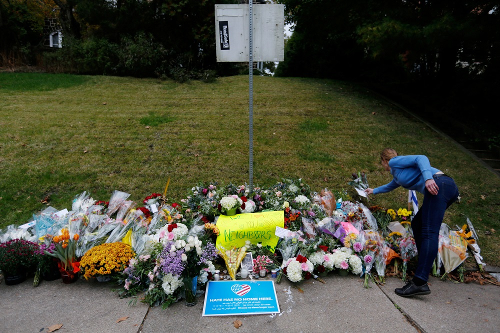 A woman places flowers on an impromptu memorial at the Tree of Life synagogue where 11 worshippers were murdered during Saturday's shooting at the synagogue in Pittsburgh, Pennsylvania, October 28, 2018. u00e2u20acu201d Reuters pic