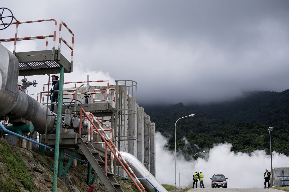 This picture taken on August 3, 2018, shows workers near the cooling towers of the Maibarara Geothermal plant in Santo Tomas, Batangas, south of Manila. u00e2u20acu201d AFP pic 