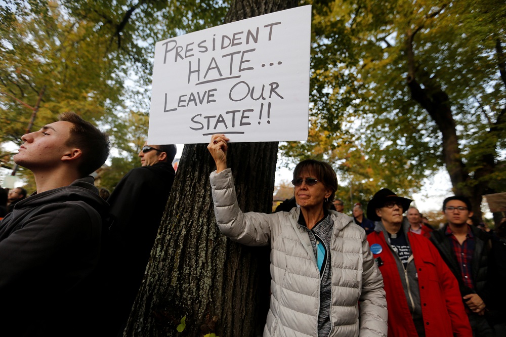 A participant in the march in memory of the victims of the Tree of Life Synagogue shooting, holds a sign opposing US President Donald Trump, in Pittsburgh, Pennsylvania, October 30, 2018. u00e2u20acu201d Reuters pic