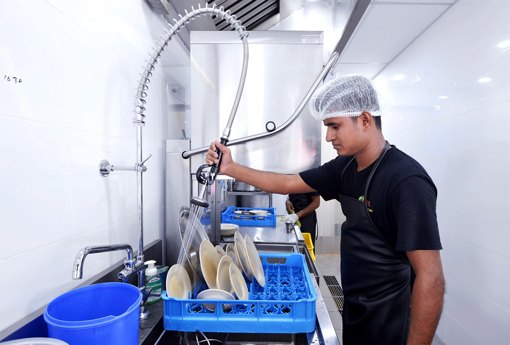 RBL staff first rinse the dirty plates before placing them into the dishwashing machine. 
