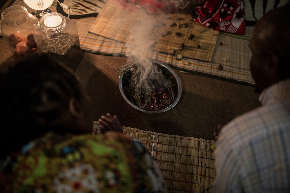 Gogo Phephisile Maseko (unseen), traditional healer and national coordinator of the Traditional Healers Organisation of South Africa attends to patients on October 1, 2018 using a blend of cannabis and other herbs in Johannesburg. u00e2u20acu201d AFP pic  