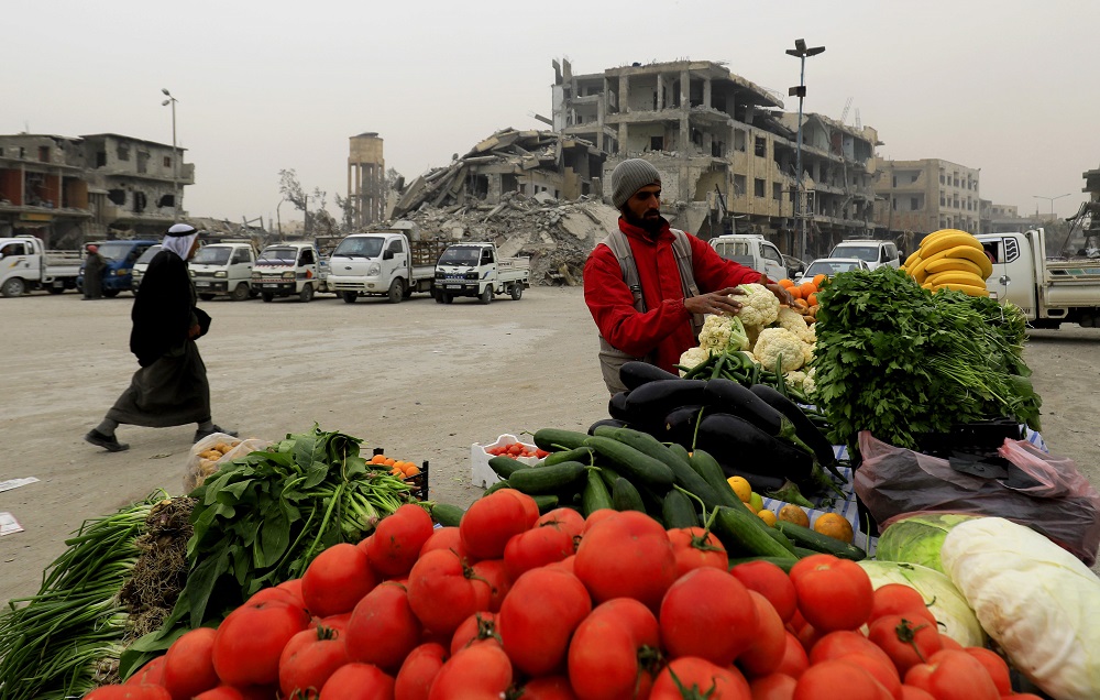 A Syrian man sells vegetables in Raqa on December 20, 2017, two months after YPG-led Syrian Democratic Forces captured the city from the Islamic State group. u00e2u20acu201d AFP pic 