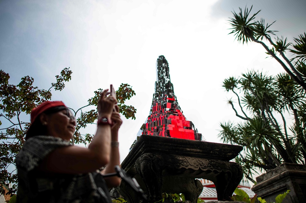 A tourist visits an art installation by Thai artist Sanitas Pradittasnee titled u00e2u20acu02dcAcross the Universe and Beyondu00e2u20acu2122, part of the Bangkok Art Biennale 2018, at the Wat Arun temple in Bangkok October 19, 2018. u00e2u20acu201d AFP pic 