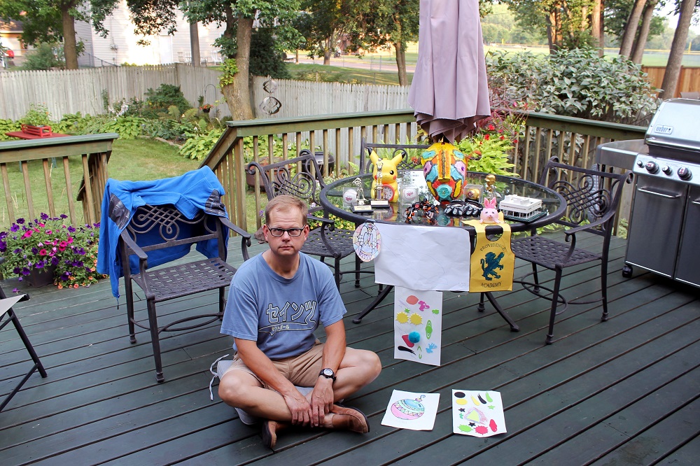 This handout self-portrait photograph taken on August 25, 2018, shows American James Cook posing with paintings and toys of his child at his motheru00e2u20acu2122s house in Crystal city, Minnesota. u00e2u20acu201d AFP pic 