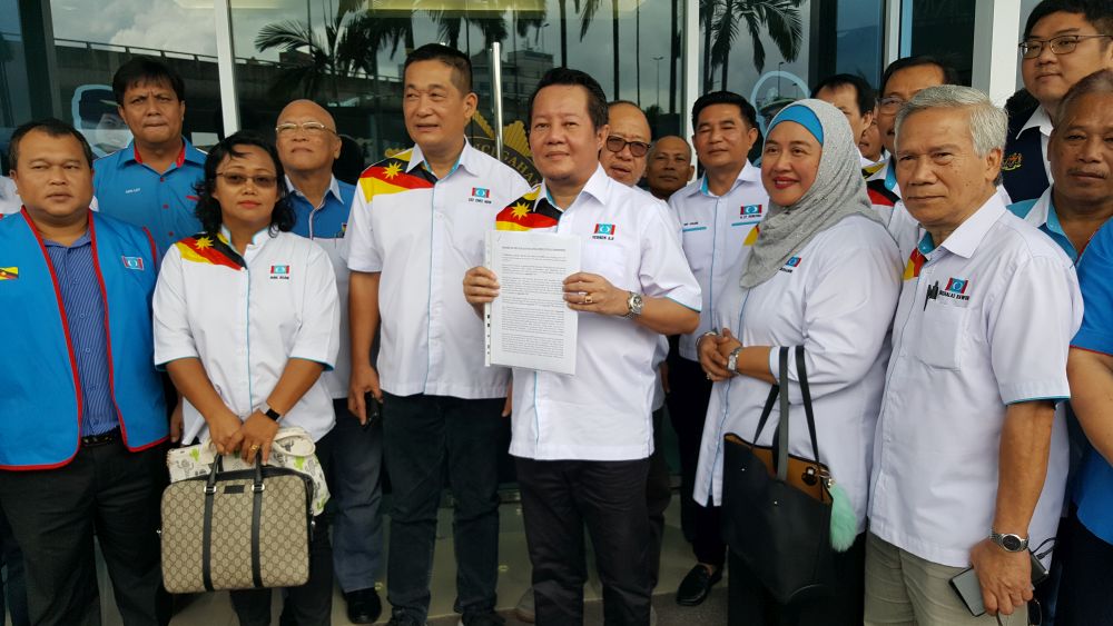 Sarawak PKR secretary Vernon Aji Kedit holds up a copy of the report lodged with the state MACC October 25, 2018. u00e2u20acu201d Picture by Sulok Tawie