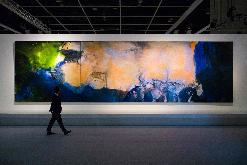 In this photo taken on September 26, 2018, a man walks past u00e2u20acu02dcJuin-Octobre 1985u00e2u20acu2122 by Chinese painter Zao Wou-Ki during a media preview for the piece at the Sothebyu00e2u20acu2122s auction house showroom in Hong Kong. u00e2u20acu201d AFP pic   