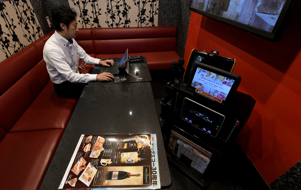 Businessman Hideyuki Aoki working in a rented room at a karaoke outlet in Tokyo August 30, 2018. u00e2u20acu201d AFP pic