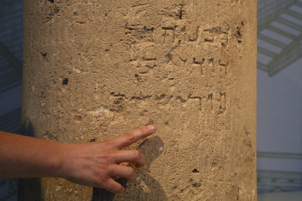 Archeologist Danit Levy points at a unique stone inscription dating to the Second Temple Period (1st Century CE), mentioning Jerusalem, written in Hebrew letters, at the Israel Museum in Jerusalem October 9, 2018. u00e2u20acu201d AFP pic