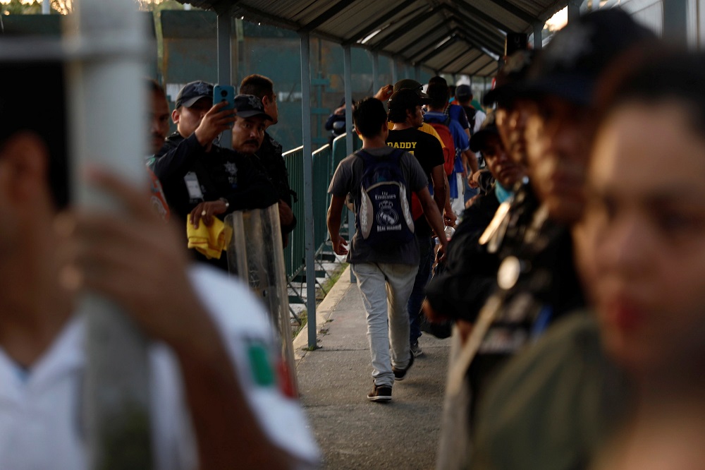 Central American migrants, part of a caravan trying to reach the US, enter the Mexican border and customs facility in Ciudad Hidalgo, Mexico October 23, 2018. u00e2u20acu201d Reuters pic