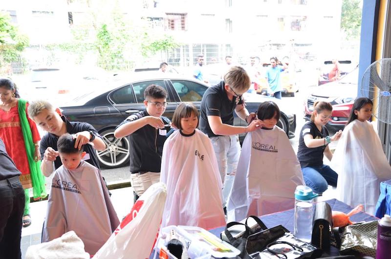 Children getting a new haircut by Cut by Elle Salon Johor Baru at last year’s carnival. — Picture courtesy of Care United