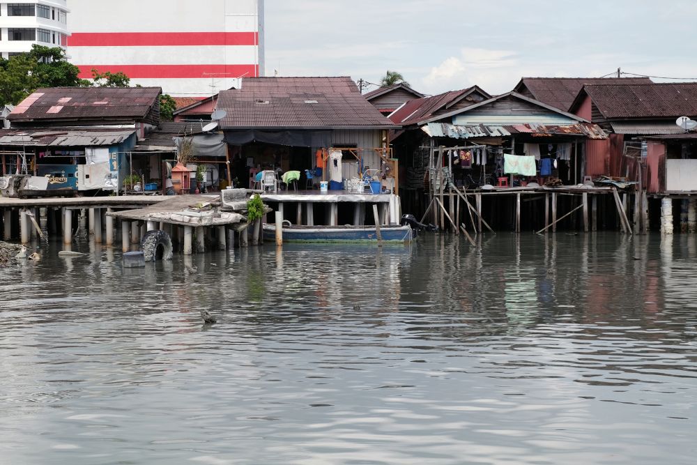 The wooden village houses on stilts were built along the wooden piers that jutted out into the sea and many families continue to live there till today. u00e2u20acu2022 Picture by KE Ooi