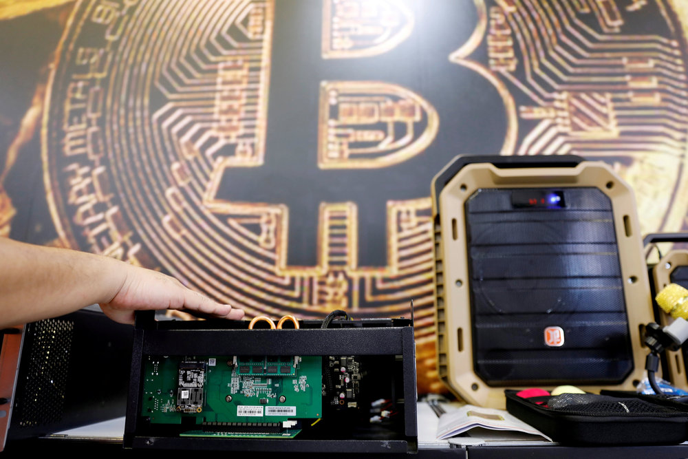 A cryptocurrency mining computer is seen in front of bitcoin logo during the annual Computex computer exhibition in Taipei, Taiwan June 5, 2018. u00e2u20acu201d Reuters pic