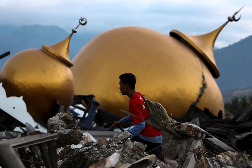 A resident walks at an area hit by the earthquake and tsunami in Palu, Central Sulawesi, Indonesia, October 4, 2018. u00e2u20acu201d Reuters pic