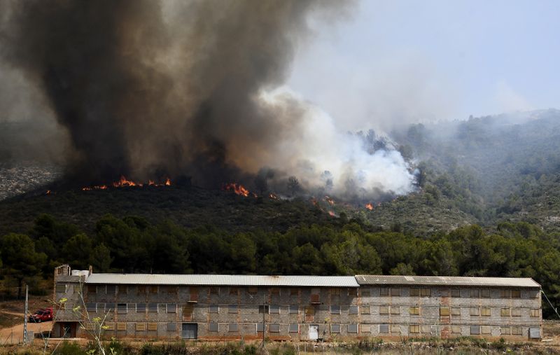 A wildfire burns in Pinet, in the eastern Spanish region of Valencia, on August 7, 2018. In the Valencia region some 2,500 people had to flee their homes to escape the flames. u00e2u20acu2022 AFP pic
