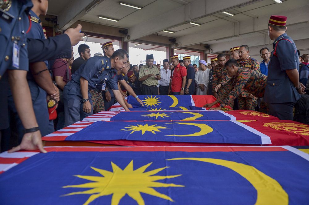 The coffins of the six firemen who died during a rescue mission last night is pictured in Shah Alam October 4, 2018. u00e2u20acu2022 Picture by Mukhriz Hazim