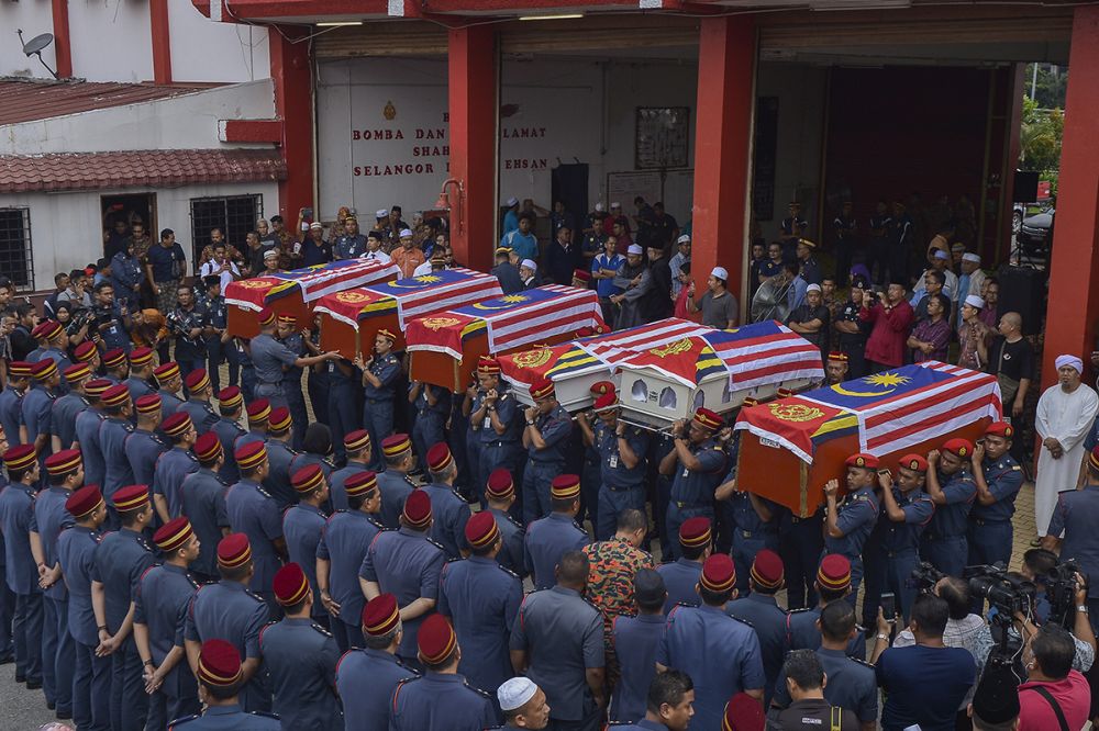 Fire and Rescue Dept personnel carry the coffins of the six firemen who died during a rescue mission last night in Shah Alam October 4, 2018. u00e2u20acu2022 Picture by Mukhriz Hazim