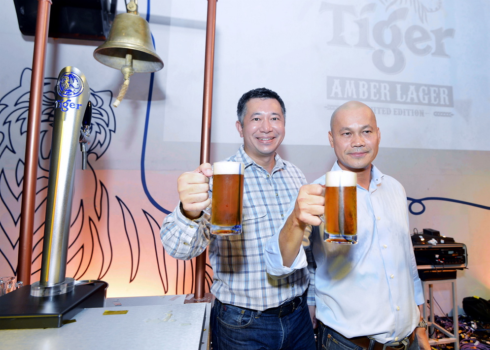Heineken Malaysia sales director Andrew Woon and managing director Roland Bala officiate The Great Brew Fest with the tapping of the first keg. u00e2u20acu201d Picture by Ham Abu Bakar