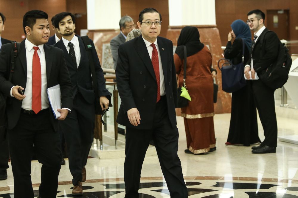 Finance Minister Lim Guan Eng (centre) arrives at Parliament in Kuala Lumpur October 22, 2018. u00e2u20acu2022 Picture by Hari Anggara