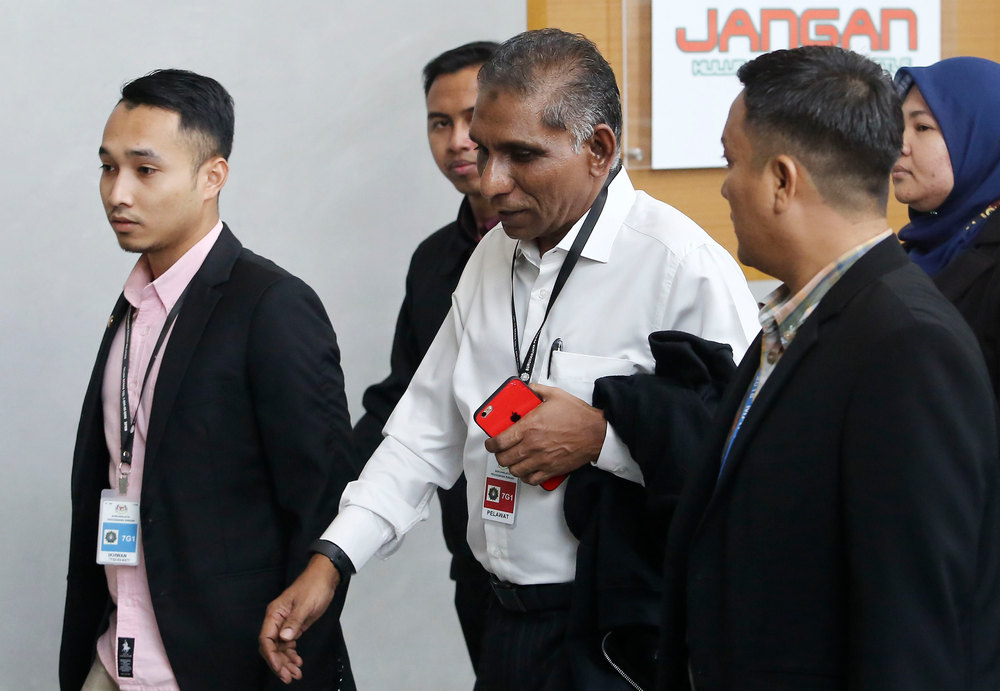 Former Treasury secretary-general Tan Sri Mohd Irwan Serigar Abdullah (centre) at the Malaysian Anti-Corruption Commission headquarters in Putrajaya October 24, 2018. u00e2u20acu201d Picture by Hari Anggara