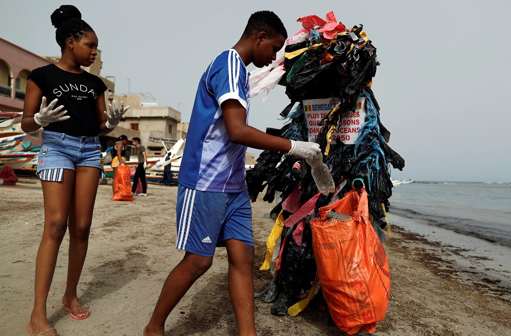 Modou Fall, 42, head of Clean Senegal Association is covered with plastic cups and bags to raise awareness of the damage on the environment caused by waste as he cleans a beach in Dakar, Senegal September 15, 2018. u00e2u20acu201d Reuters pic