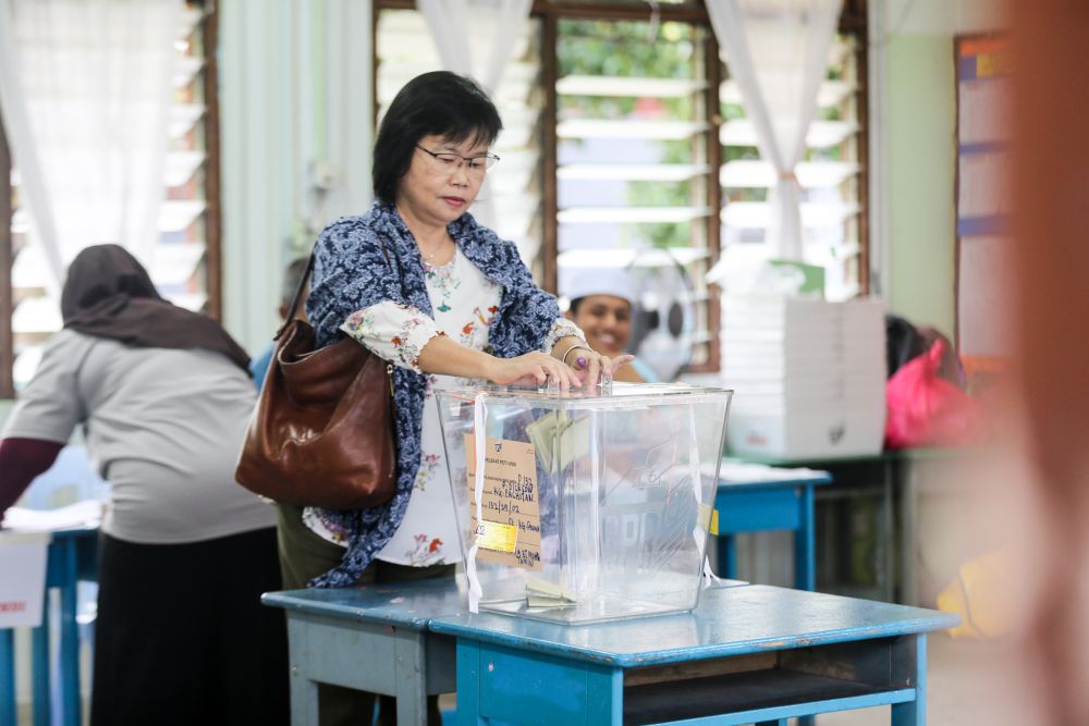 A voter casts her vote at a polling centre in Port Dickson October 13, 2018. u00e2u20acu2022 Picture by Ahmad Zamzahuri