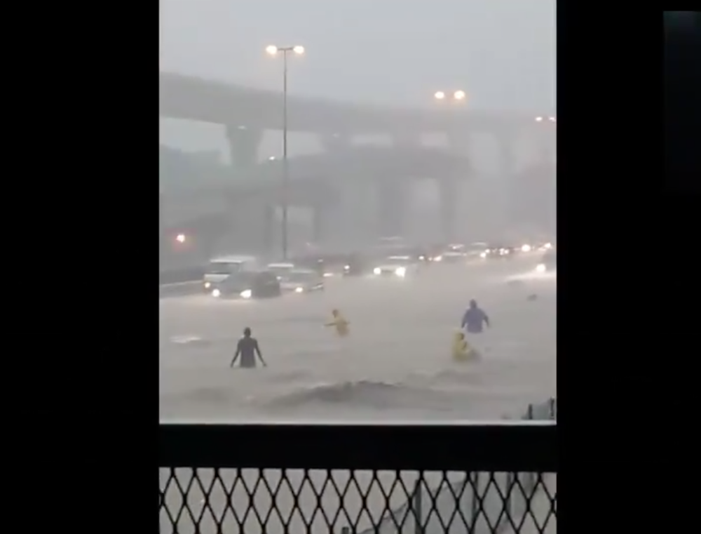 A screengrab shows people wading through waist-high waters along the LDP yesterday.