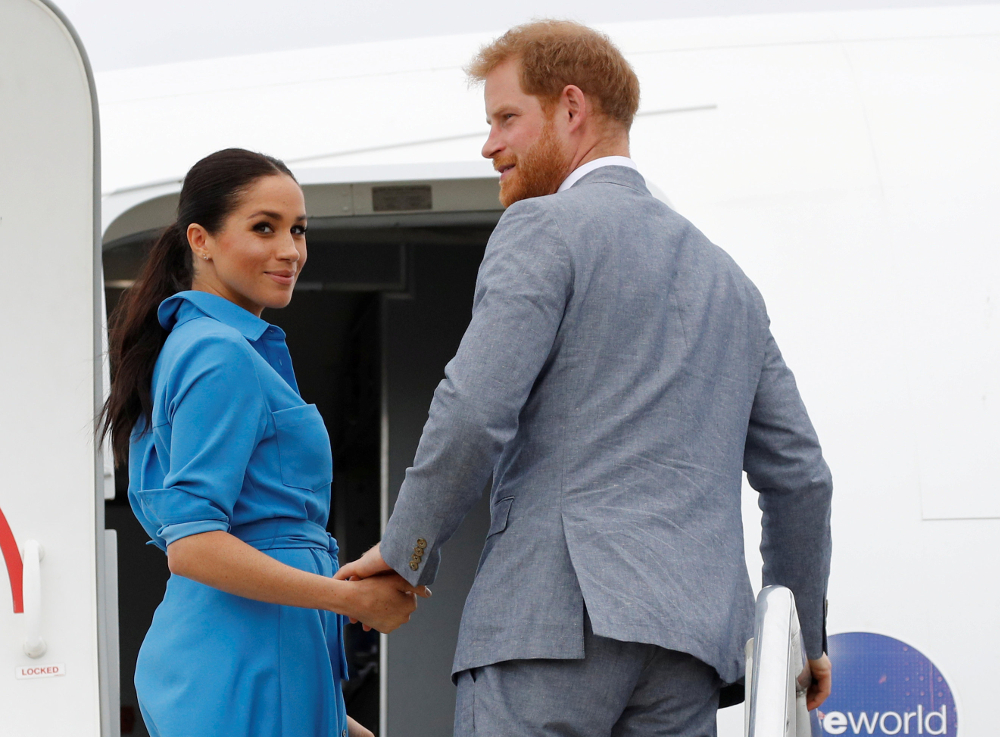 Britainu00e2u20acu2122s Prince Harry and Meghan, Duchess of Sussex look on before departing from Fuau00e2u20acu2122amotu International Airport in Tonga October 26, 2018. u00e2u20acu201d Picture by Phil Noble/Pool via Reuters 