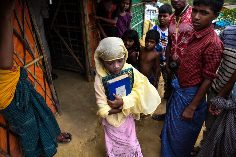 Saleema Khanam, 8, leaves her tent as she goes to a madrassa (Islamic seminary) for her studies in Kutupalong camp, in Ukhia near Cox's Bazar. u00e2u20acu201d AFP pic