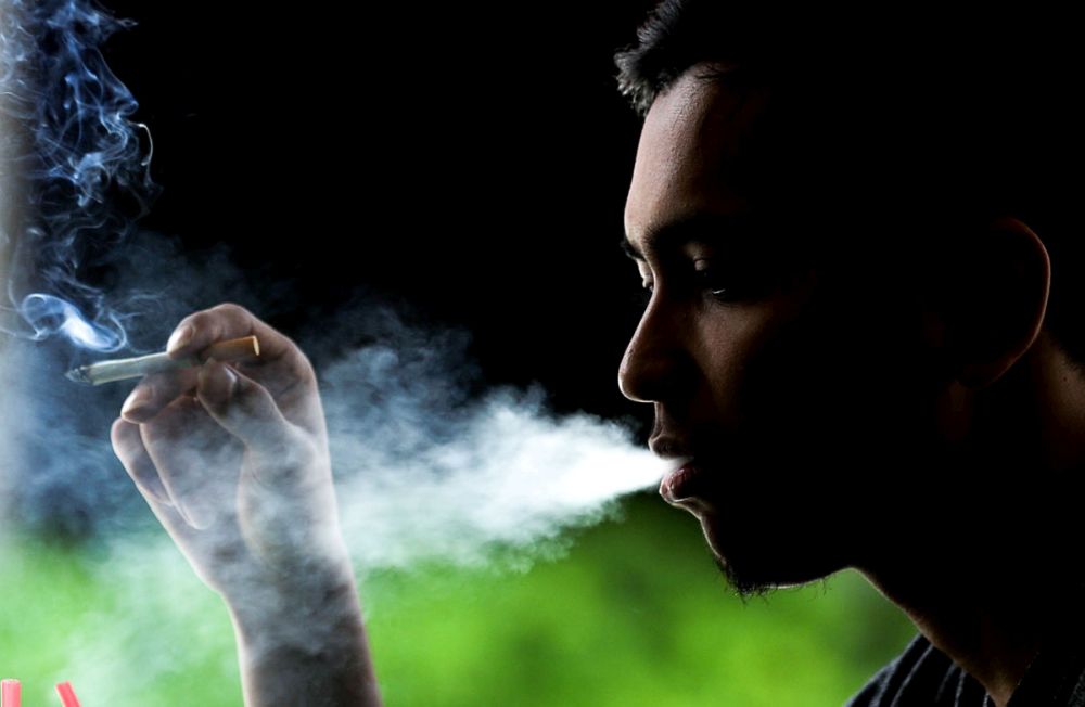 A man is pictured smoking at a restaurant in Lebuh Clarke, George Town October 9, 2018. u00e2u20acu201d Picture by Sayuti Zainudin