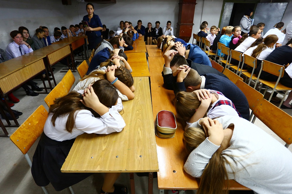 Schoolchildren cover their heads with their hands as they take part in security exercises in school in the Kiev-controlled village of Sartana, Donetsk region October 2, 2018. u00e2u20acu201d AFP pic