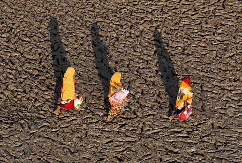 Women walk on the muddy banks of the Ganges river after taking a holy dip, in Allahabad, India September 25, 2018. u00e2u20acu201d Reuters pic