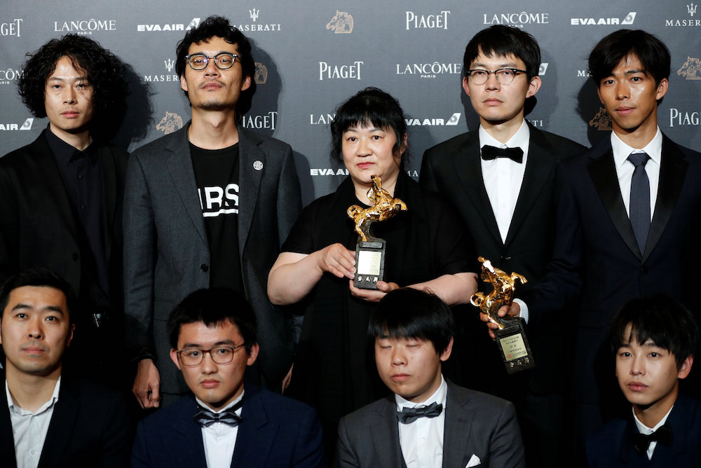 The late China’s director Hu Bo’s mother (centre) poses with cast members of ‘An Elephant Sitting Still’ after winning Best Feature Film at the 55th Golden Horse Awards in Taipei November 18, 2018. — Reuters pic