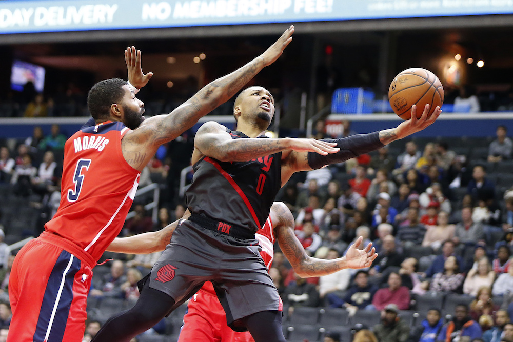 Portland Trail Blazers guard Damian Lillard shoots past Washington Wizards forward Markieff Morris during their NBA game in Washington November 18, 2018. u00e2u20acu201d Amber Searls-USA TODAY Sports pic via Reuters