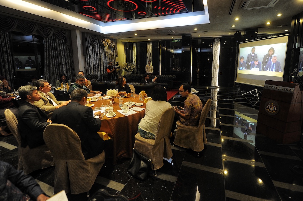 Foreign Minister Datuk Saifuddin Abdullah (left, light-coloured jacket) watches a livecast of Malaysia’s Universal Periodic Review (UPR) at the United Nations in Geneva November 8, 2018. — Picture by Shafwan Zaidon