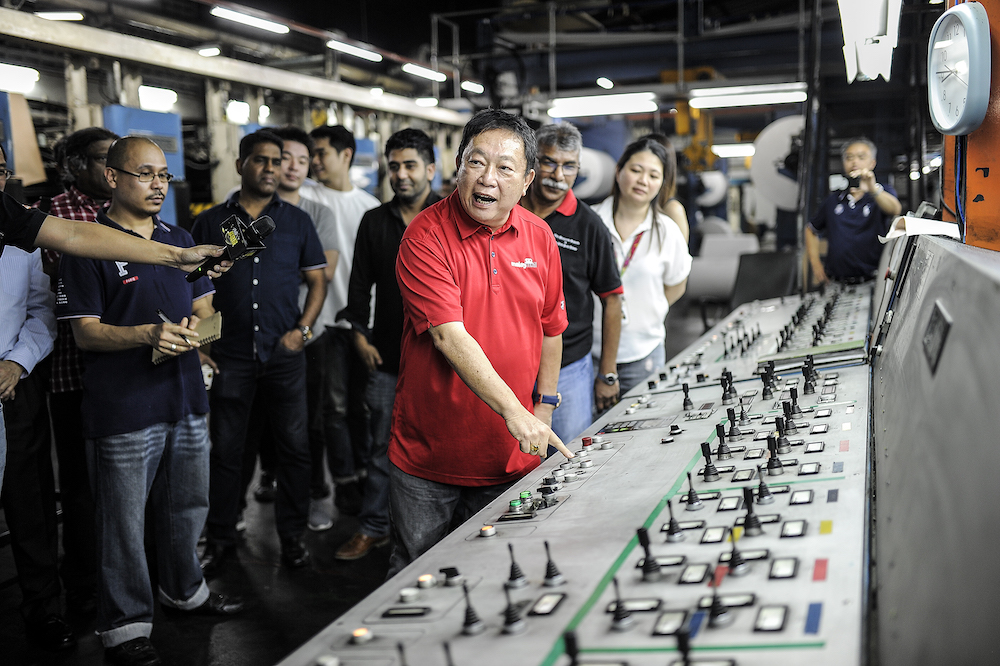Malay Mail editor-in-chief, Datuk Wong Sai Wan, starts up the press to commence printing for the newspaper’s final edition in Petaling Jaya November 30, 2018. — Picture by Shafwan Zaidon