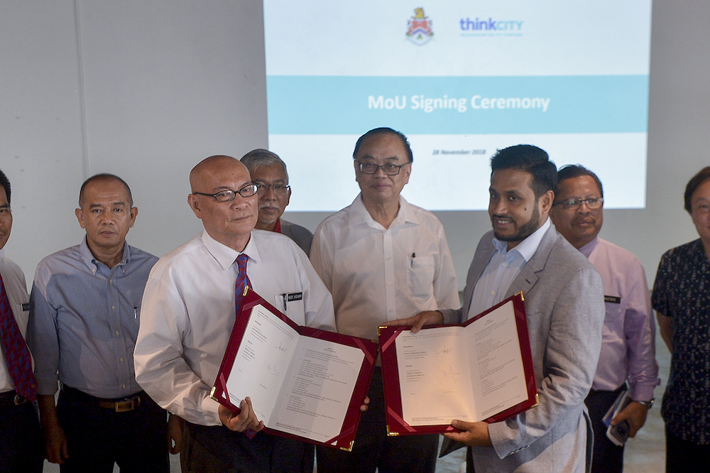 Kuala Lumpur Mayor Datuk Nor Hisham Ahmad Dahlan and Managing Director of Think City Hamdan Abdul Majeed pose with the MoU document in Kuala Lumpur, November 28, 2018. u00e2u20acu201d Picture by Mukhriz Hazim