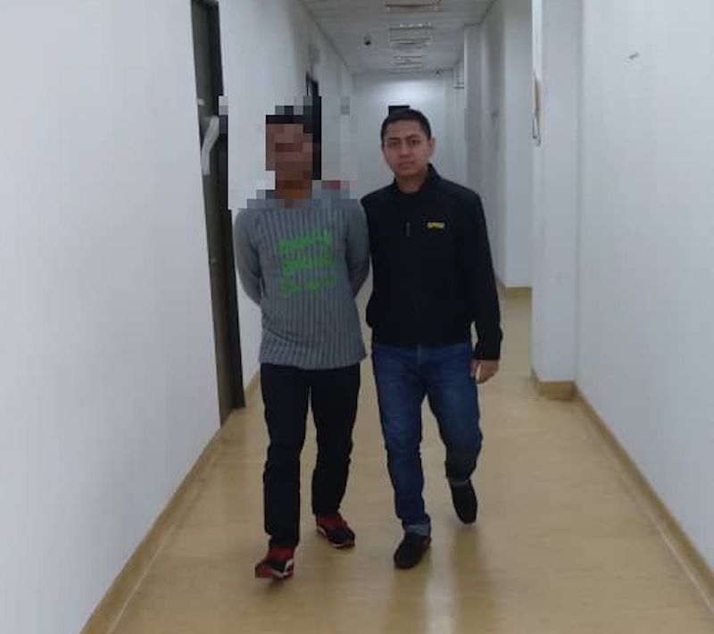 A MACC officer escorts the policeman (left) who was arrested and detained to facilitate investigations for demanding and receiving bribes. u00e2u20acu201d Picture courtesy of the Malaysian Anti-Corruption Commission