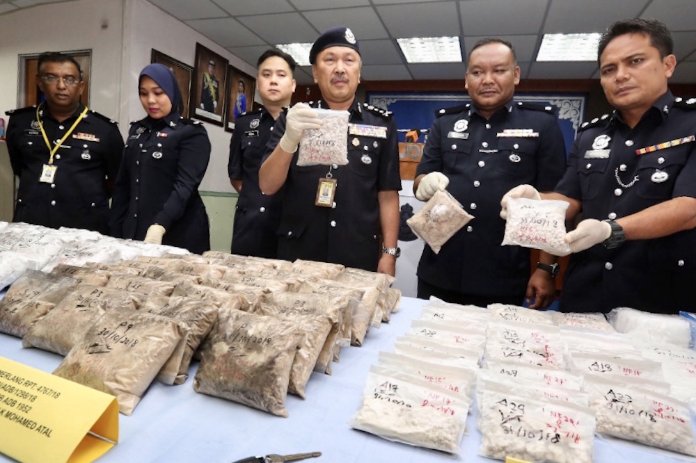 Johor deputy police chief Datuk Mohd Kamarudin Md Din displays the seized drugs worth more than RM3 million at the Johor police contingent headquarters today. u00e2u20acu201d Picture by Ben Tan