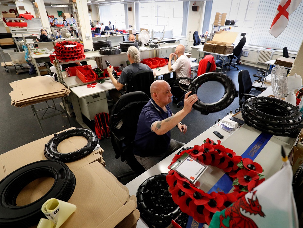 Alex Conway (centre) finishes working on a wreath at The Poppy Factory in Richmond, west London on October 11, 2018 ahead of Armistice Day and Remembrance Sunday. u00e2u20acu201d AFP pic 