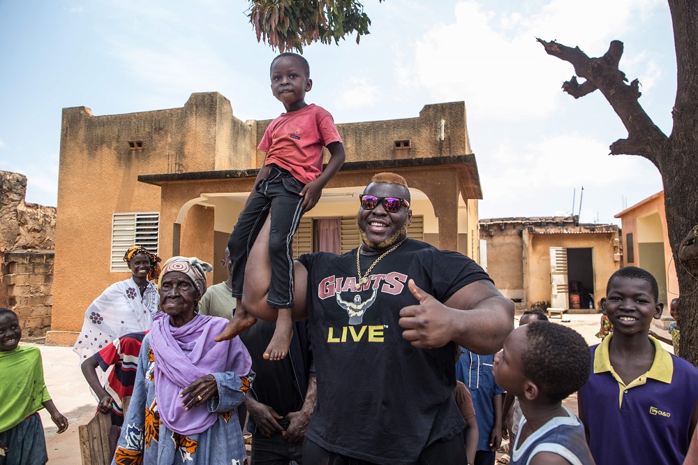 Cheick Ahmed Al-Hassan Sanou aka Iron Biby lifts a child in the courtyard of his grandmother’s home in Bobo-Dioulasso, second biggest city of Burkina Faso September 24, 2018. — AFP pic