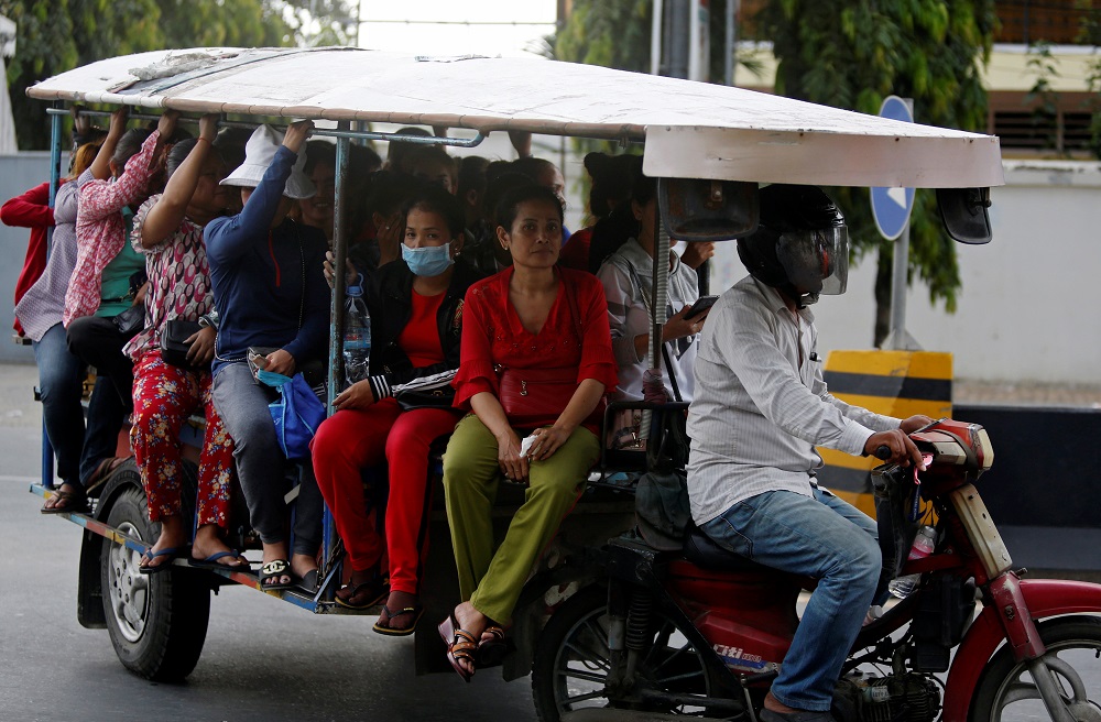 Garment workers travel back home as they leave a factory after work, on the outskirts of Phnom Penh, Cambodia October 16, 2018. u00e2u20acu201d Reuters pic