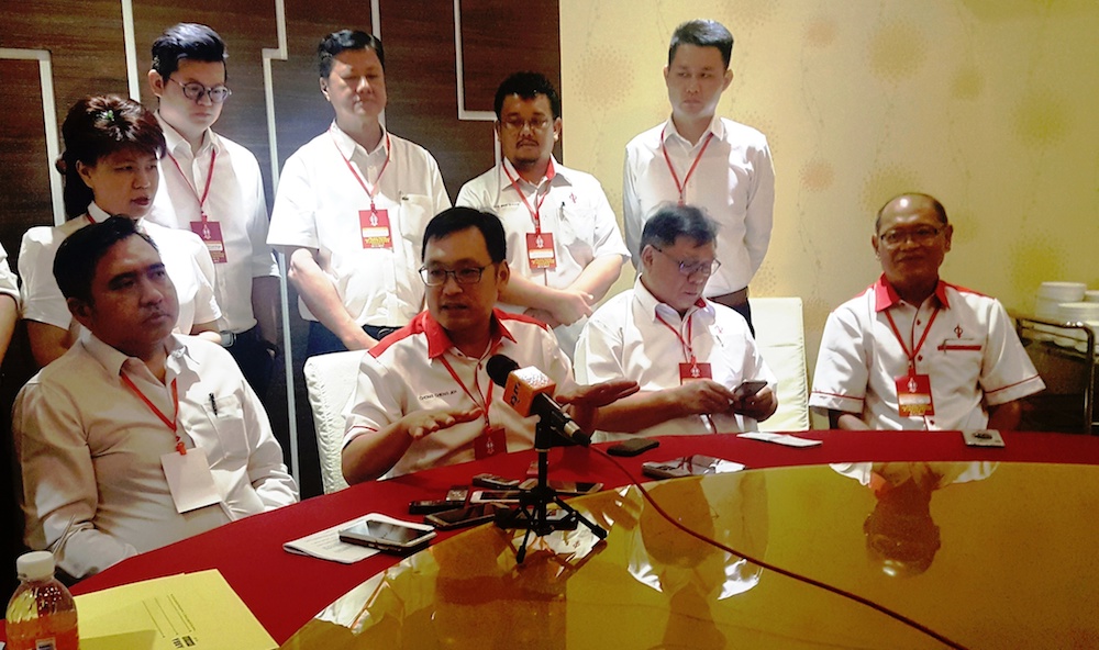 Sarawak DAP chairman Chong Chieng Jen (seated, 2nd from left) and Anthony Loke (left) speak to reporters in Kuching November 4, 2018. u00e2u20acu201d Picture by Sulok Tawie