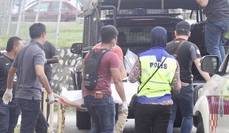 Police personnel at the murder scene where a couple were brutally hacked to death in a flat in Taman Ungku Tun Aminah, Johor Baru today. u00e2u20acu201d Picture by Ben Tan