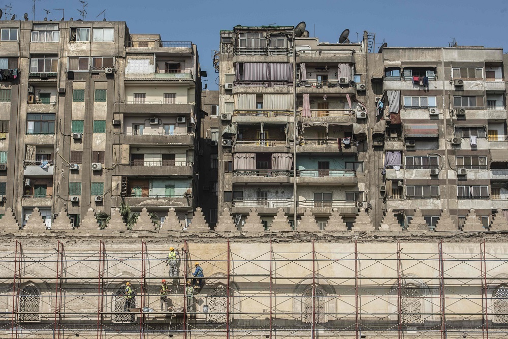 A picture taken on October 16, 2018, shows workers standing on scaffolding during renovation work on the 13th century al-Zahir Baybars mosque in the capital Cairo. — AFP pic