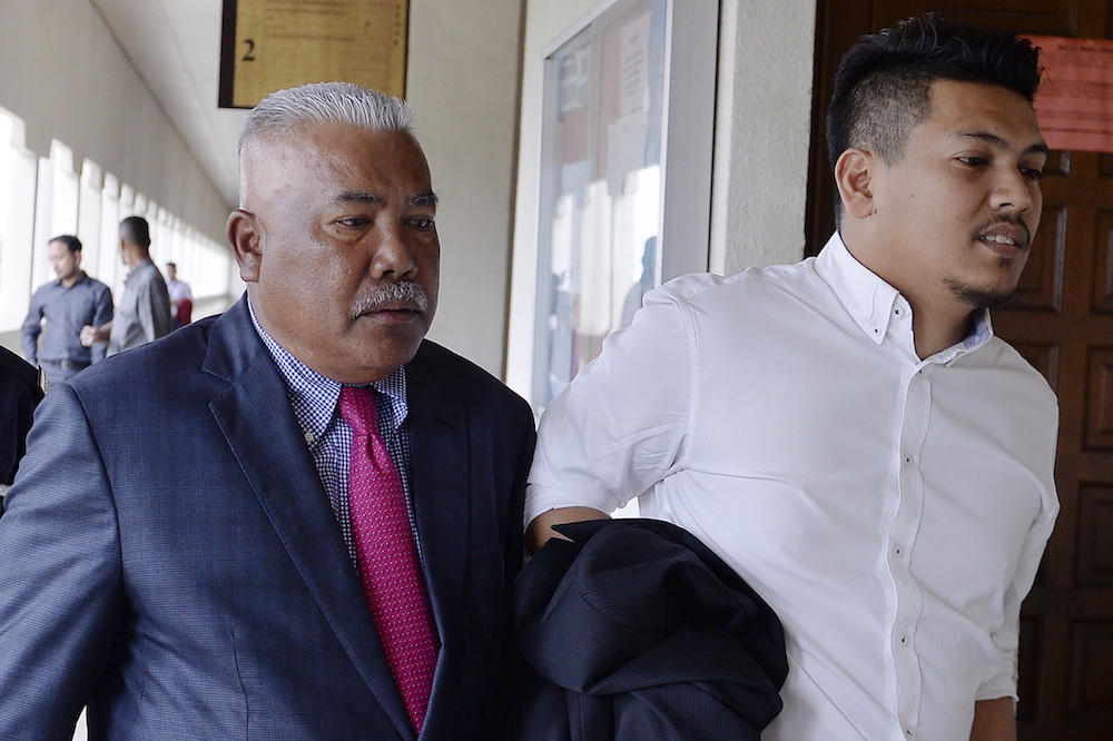 Datuk Mohd Arif Ab Rahman and his son Ahmad Zukhairi attend court in Kuala Lumpur November 14, 2018. u00e2u20acu201d Bernama pic