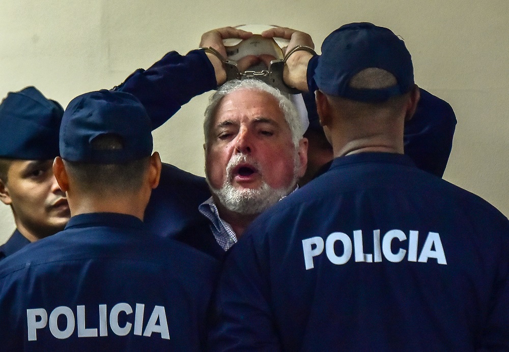 Former Panama's president (2009-2014) Ricardo Martinelli shouts at the press saying his rights are being violated, as he is escorted to a court room at the Supreme Court in Panama City, on November 19, 2018. u00e2u20acu201d AFP pic