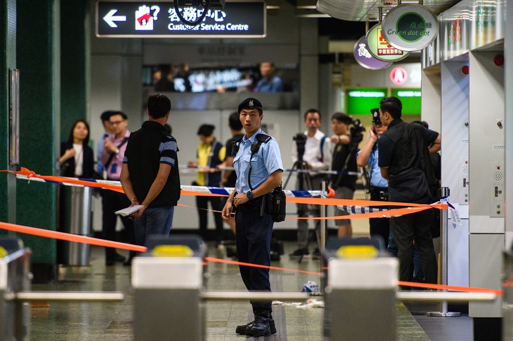 A policeman stands guard within a cordoned off area in Sham Shui Po MTR underground station in Hong Kong on November 7, 2018, after police shot a knifeman when he tried to attack them, according to officials. u00e2u20acu201d AFP pic