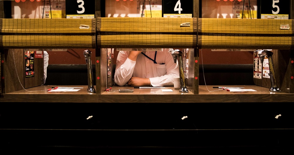 In this photo taken on August 29, 2018, a customer waits in a partitioned booth after ordering ramen noodles at a chain restaurant in Tokyo. u00e2u20acu201d AFP pic